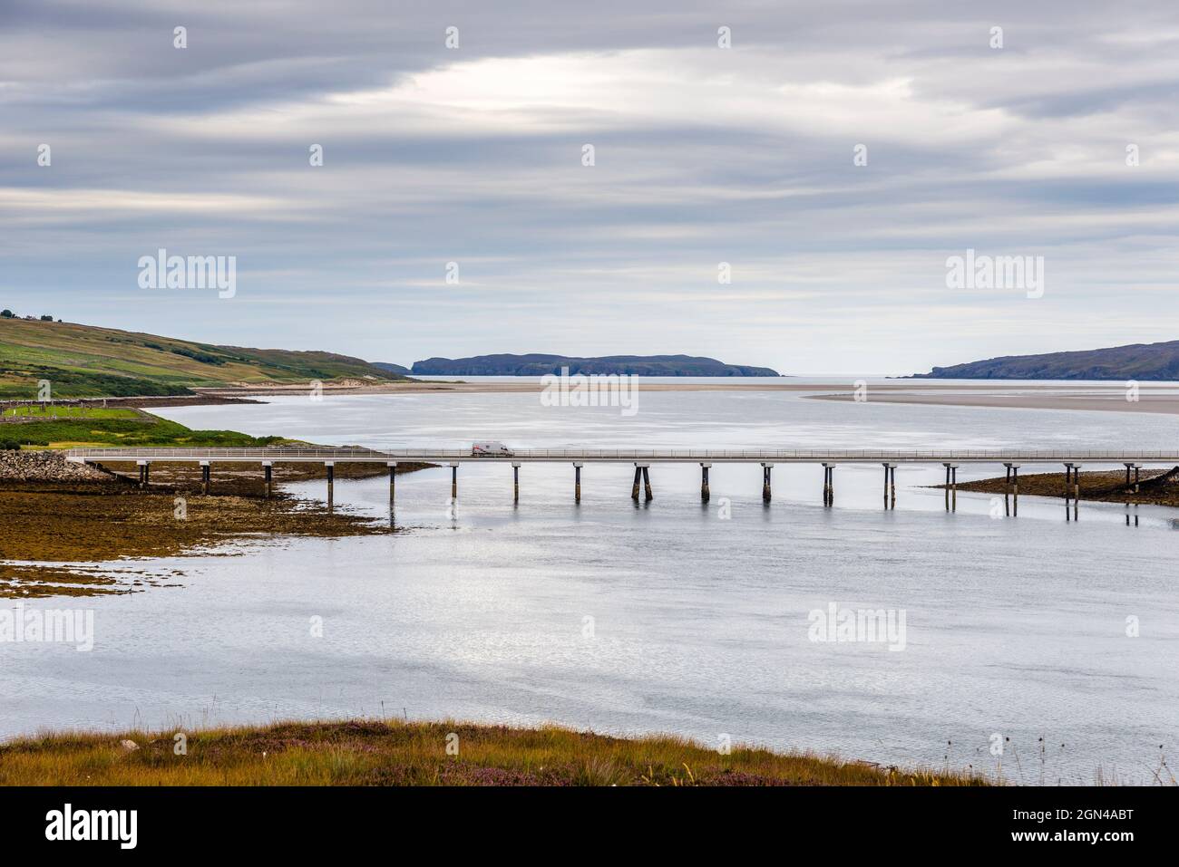 Un furgone attraversa il ponte Kyle of Tongue sulla A838, parte della Scozia settentrionale NC500, con Tongue Bay e l'isola Eilean Nan Ron oltre di loro. Foto Stock