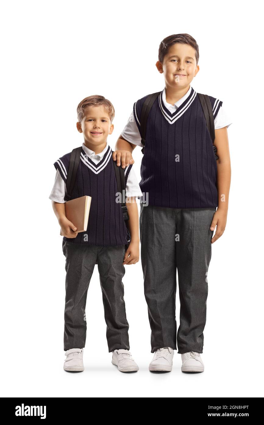 Ragazzi più giovani e anziani in uniforme che si posano insieme isolati su sfondo bianco Foto Stock