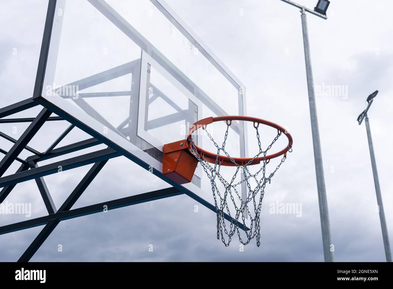 Basket backboard con anello, elaborazione foto a colori. Foto in bianco e nero e anello evidenziato in rosso. Concentratevi sul basket come obiettivo. Foto Stock