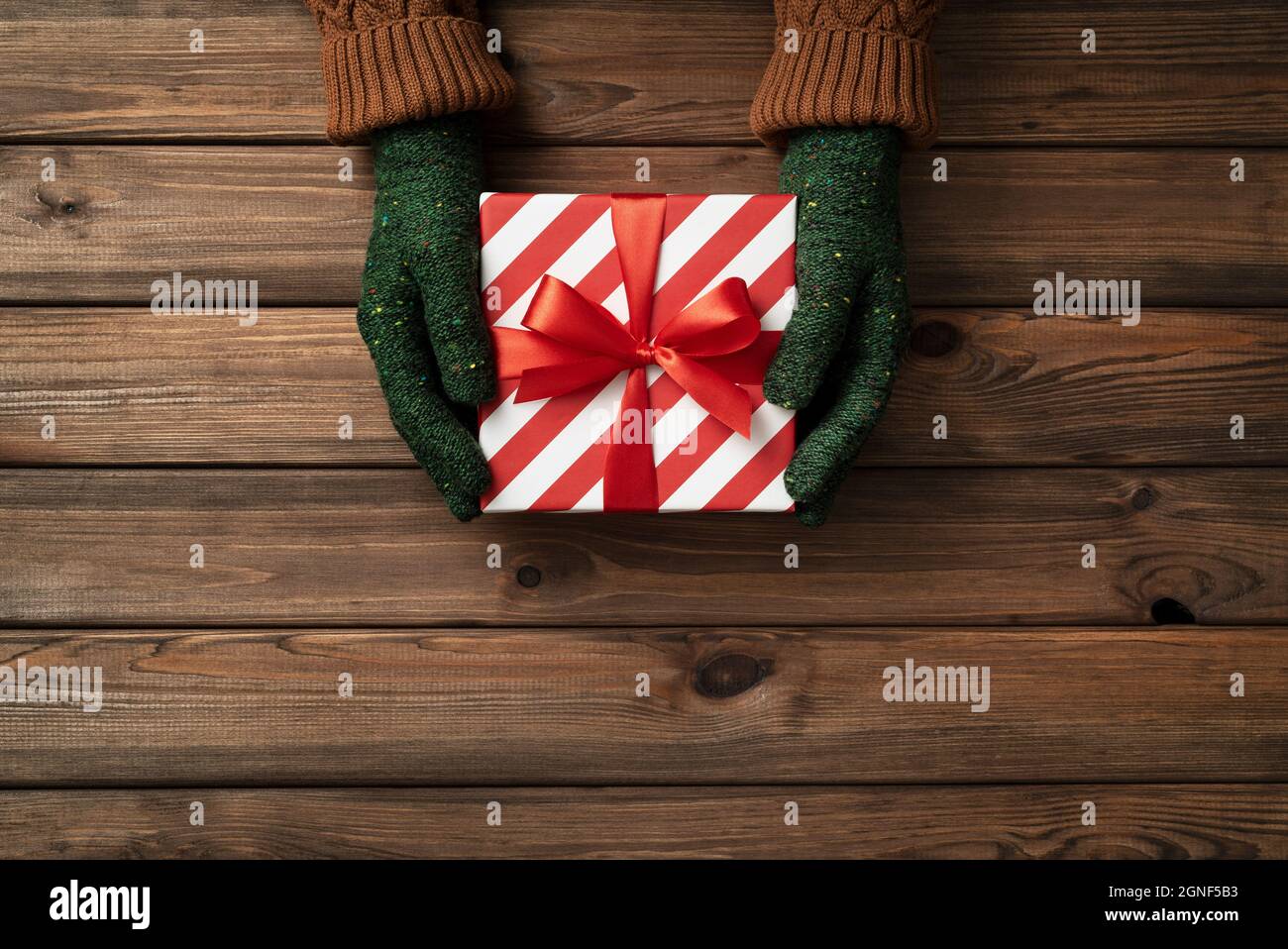Lo scambio presenta giorno. Una scatola con un regalo di Natale nelle mani delle donne Foto Stock