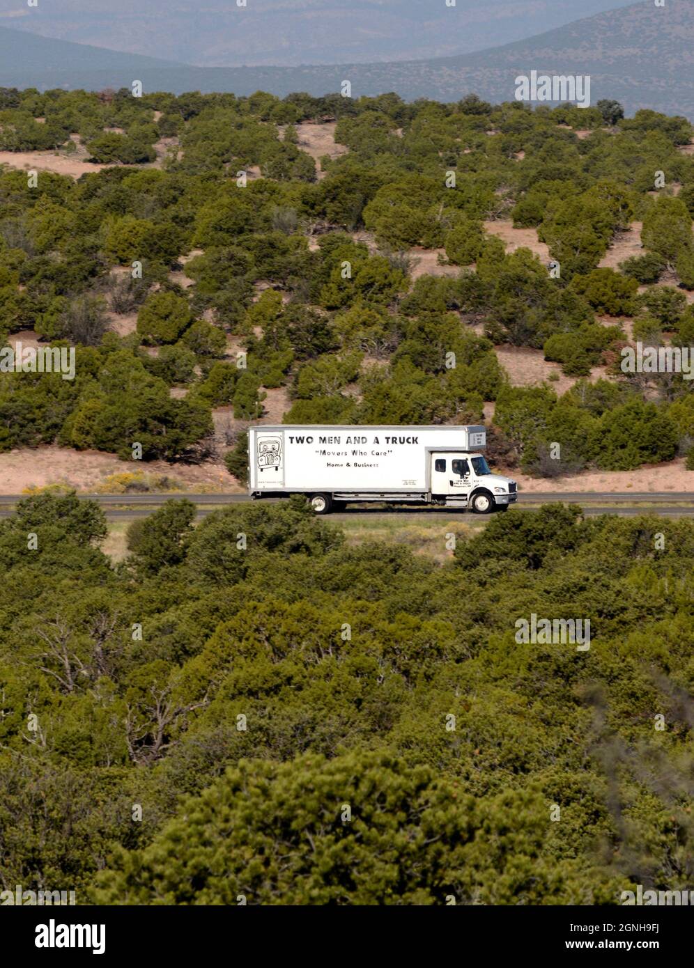 Un furgone in movimento viaggia lungo un'autostrada rurale nel New Mexico. Foto Stock