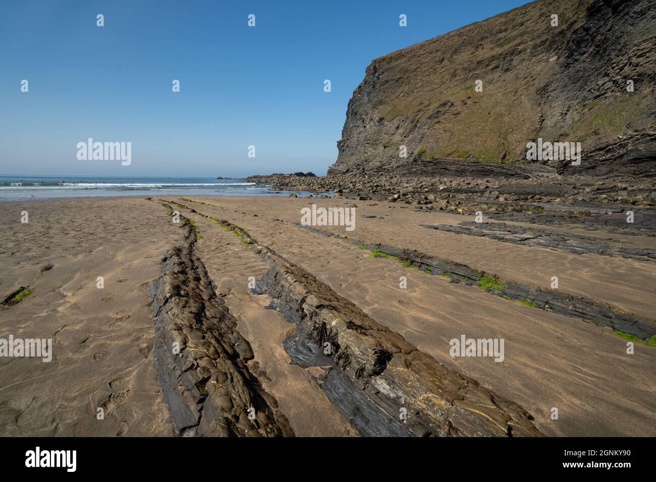 Spettacolare costa della Cornovaglia con sporgenze rocciose e spiaggia sabbiosa con bassa marea Foto Stock