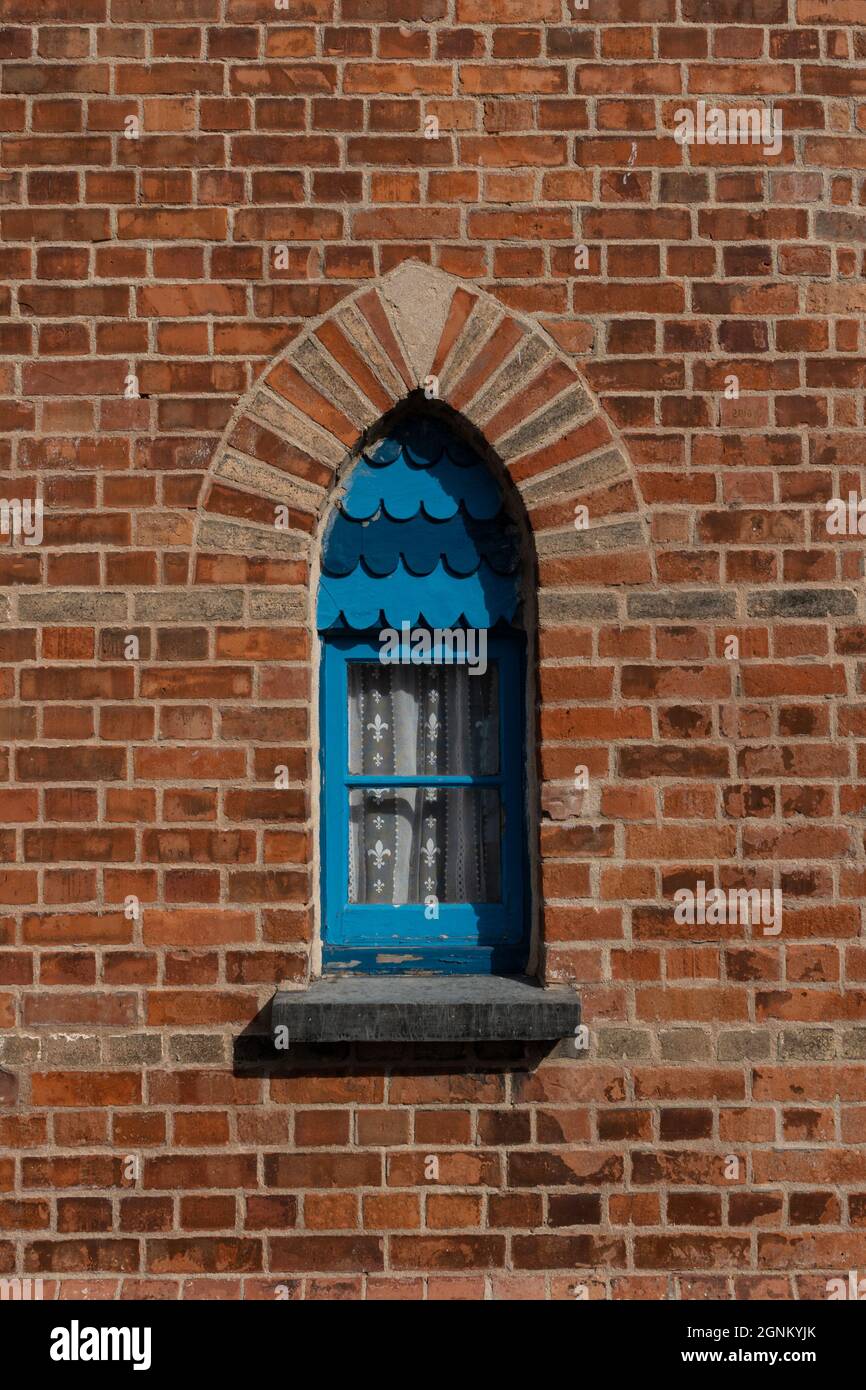 Finestra ad arco blu con scale decorative in mattoni rossi, Cornovaglia Foto Stock