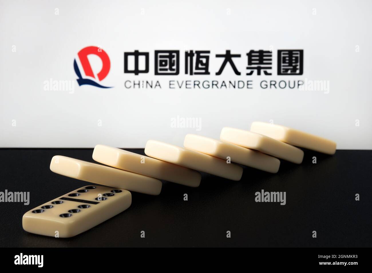 Domino Block e logo Blurred China Evergrande Group. Concetto. Stafford, Regno Unito, 26 settembre 2021. Foto Stock
