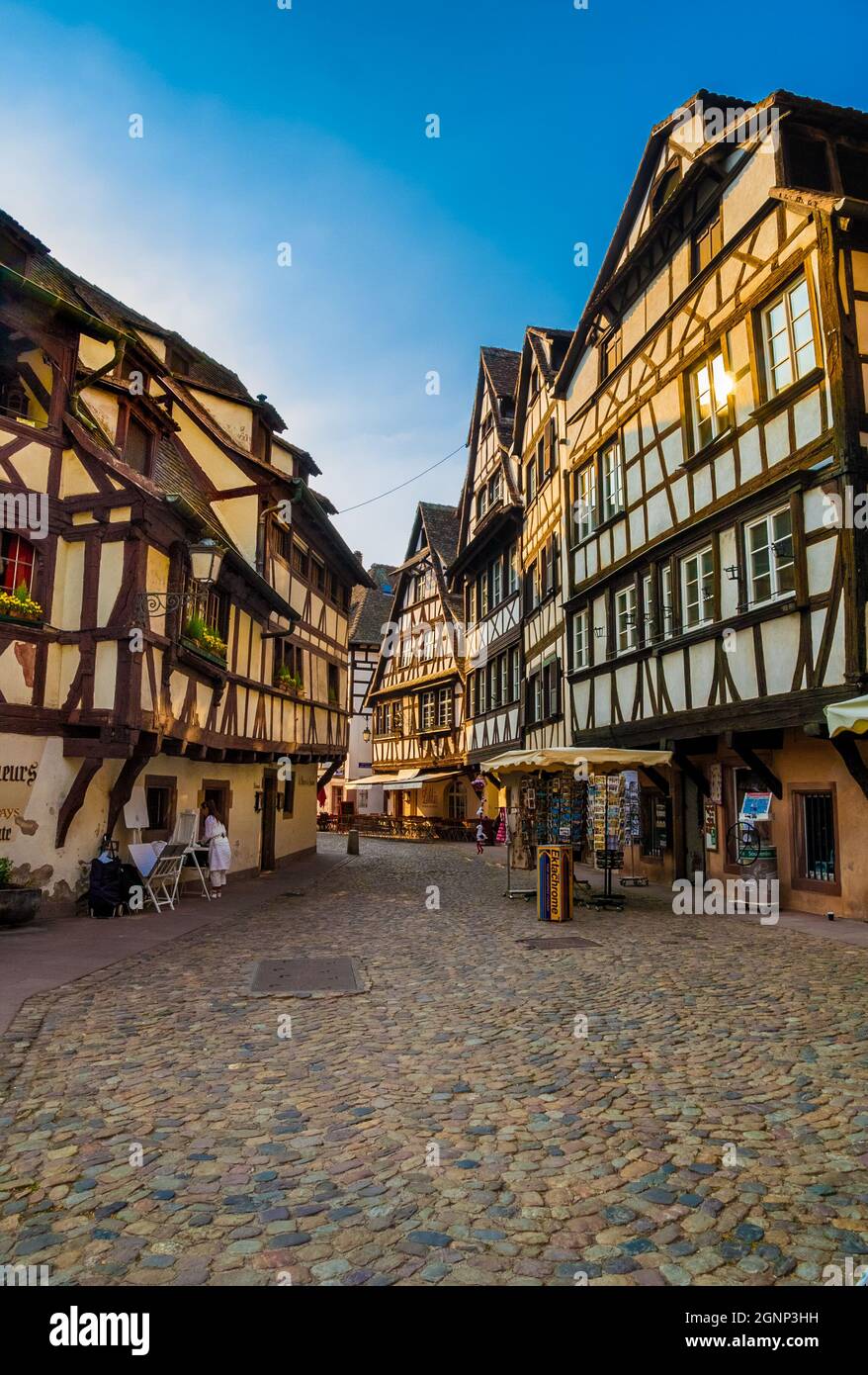 Grande vista sulla strada acciottolata di pietra Rue du Bain-aux-Plantes nel quartiere storico di Strasburgo la Petite France con negozi e ristoranti in... Foto Stock