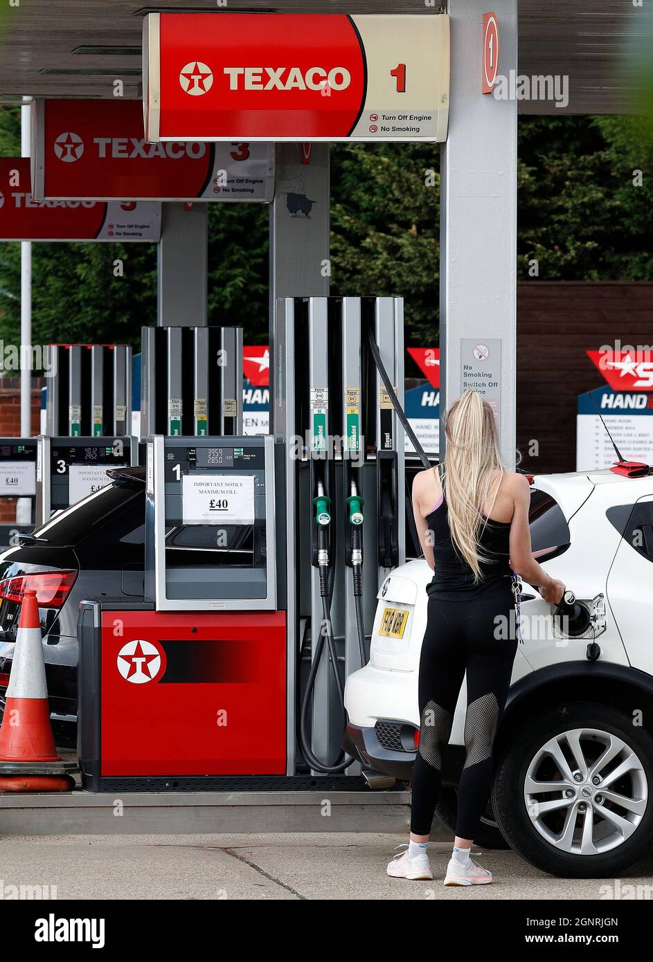 Loughborough, Leicestershire, Regno Unito. 27 settembre 2021. Un conducente si rifornisce in un distributore di benzina Texaco con segnali che indicano una spesa massima di £ 40 dopo che il governo ha esortato le persone a continuare ad acquistare benzina come di consueto, nonostante i problemi di fornitura che hanno chiuso alcune stazioni. Credit Darren Staples/Alamy Live News. Foto Stock