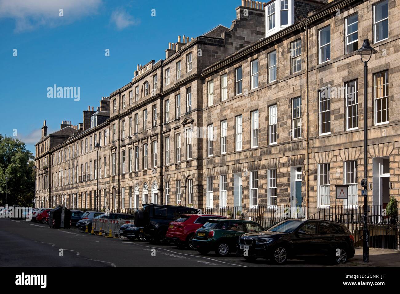 Il sole mattutino colpisce il lato nord di London Street, una terrazza di edifici di locazione nella New Town di Edimburgo Foto Stock