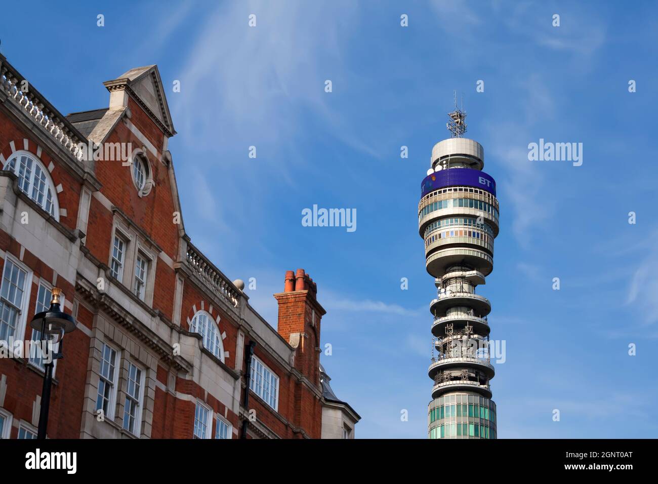 Il sole splende sulla BT Tower nel centro di Londra (Inghilterra), tra gli edifici di Fitzrovia Foto Stock