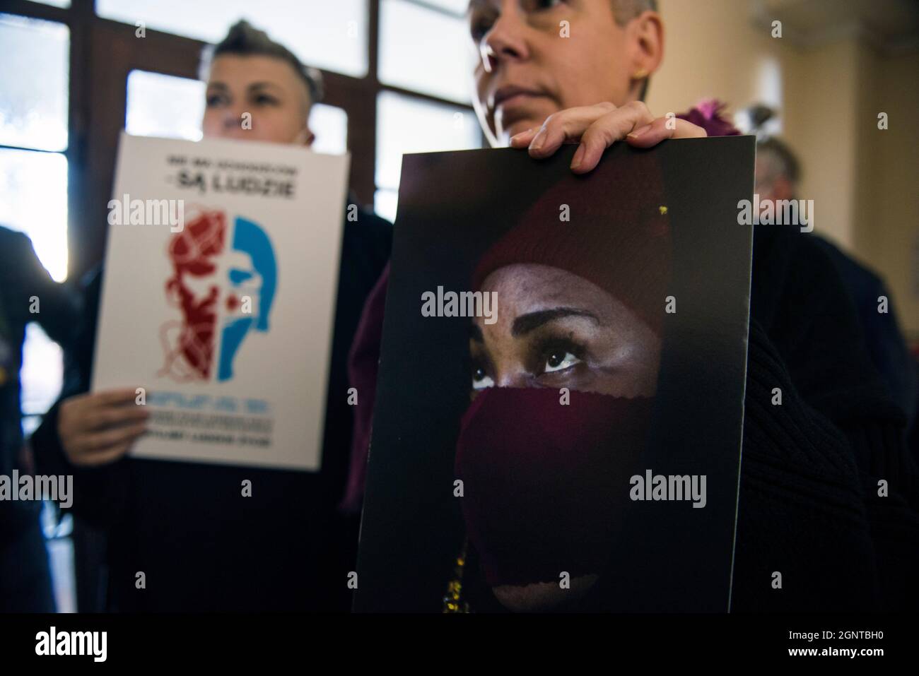 Varsavia, Polonia. 27 settembre 2021. Un attivista detiene un'immagine di un rifugiato bloccato al confine tra Polonia e Bielorussia durante la dimostrazione.gli attivisti del gruppo Obywatele RP (cittadini della RP) si sono rotti nella sede della Croce Rossa polacca (PCK - Polski Czerwony Krzyz) e hanno iniziato uno sciopero sit-in, Protestare contro la situazione di crisi migratoria al confine con la Bielorussia e chiedere aiuti umanitari decisivi per le persone bloccate al confine tra Polonia e Bielorussia. Credit: SOPA Images Limited/Alamy Live News Foto Stock