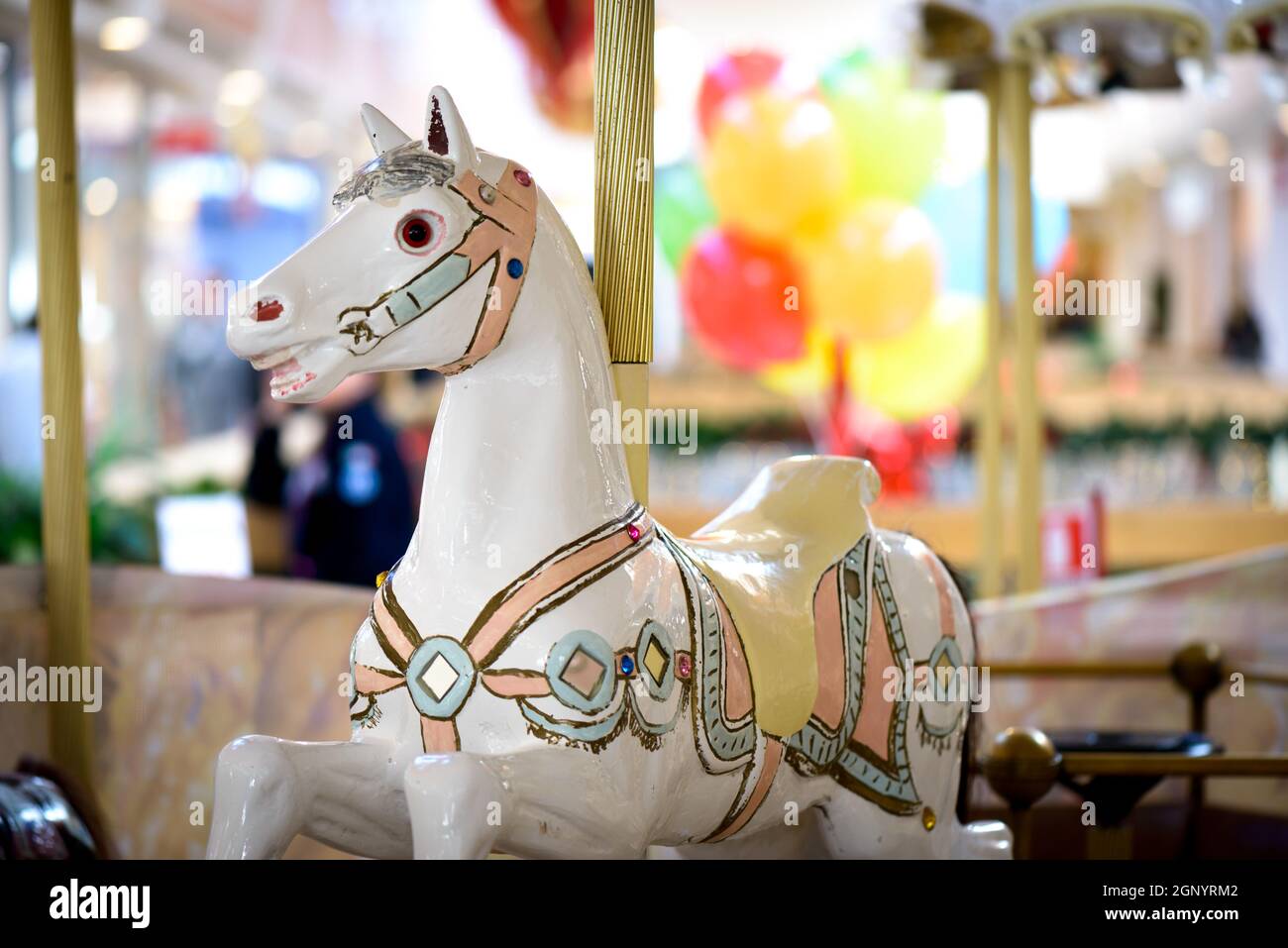 Bel cavallo bianco giostra wit sfondo colorato Foto Stock