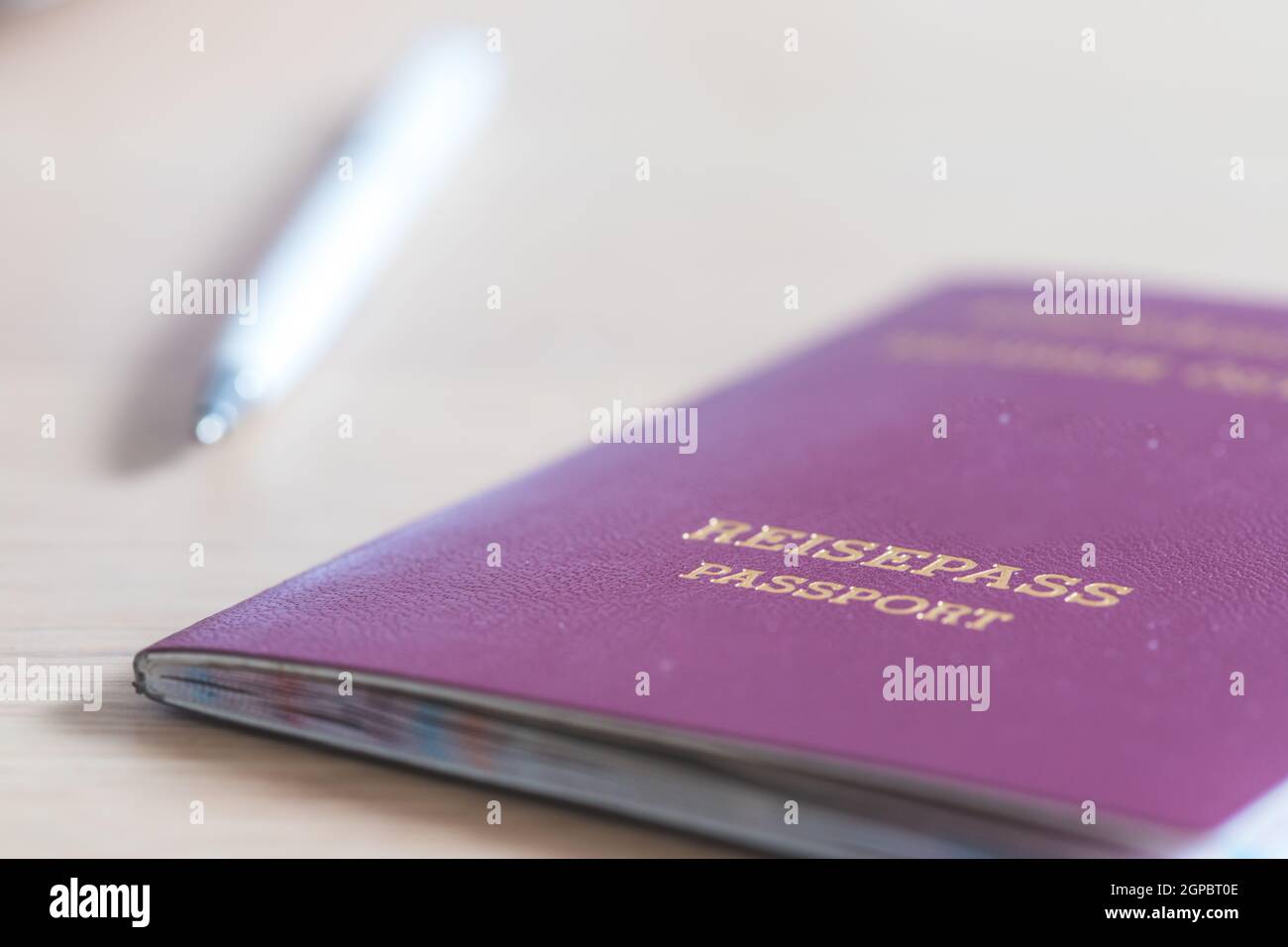 Primo piano con le dita in possesso di un passaporto per viaggiare, aeroporto, "Reisepass Passport" Foto Stock