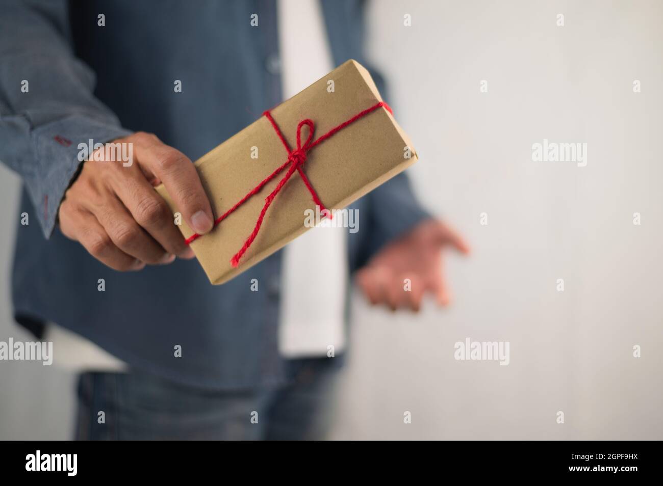 Persona che tiene la scatola del regalo, la scatola del regalo di nuovo anno, la scatola del regalo di Natale, lo spazio della copia. Natale, anno di nascita, concetto di compleanno. Foto Stock