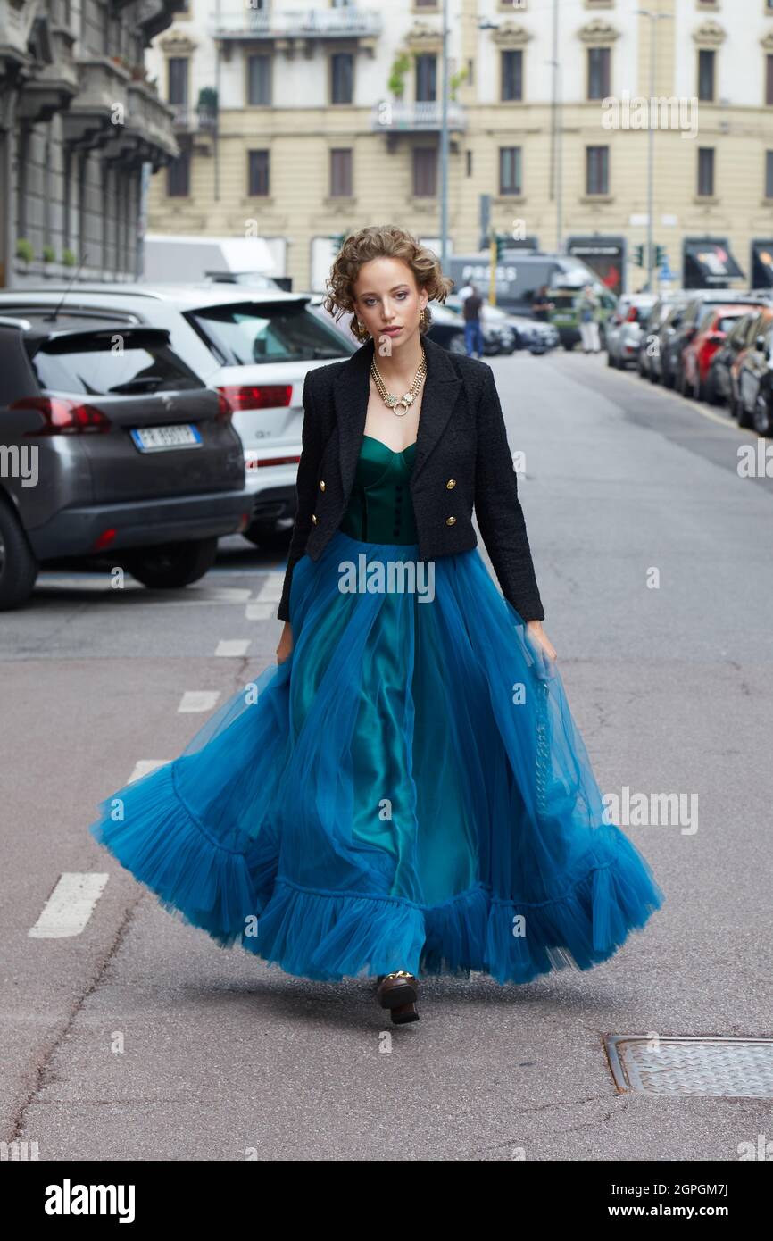 MILANO, ITALIA - 25 SETTEMBRE 2021: Donna con gonna lunga, blu, tulle,  giacca nera e top verde che cammina prima della sfilata di moda di  Salvatore Ferragamo, MIL Foto stock - Alamy