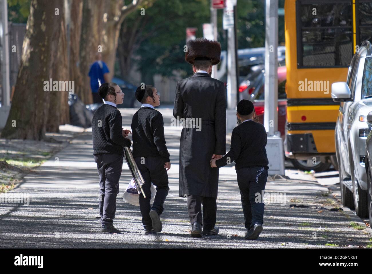 Una famiglia ebrea Hasidic simile vestito ritorna dalla sinagoga Sukkos servizi. A Williamsburg, Brooklyn, New York. Foto Stock