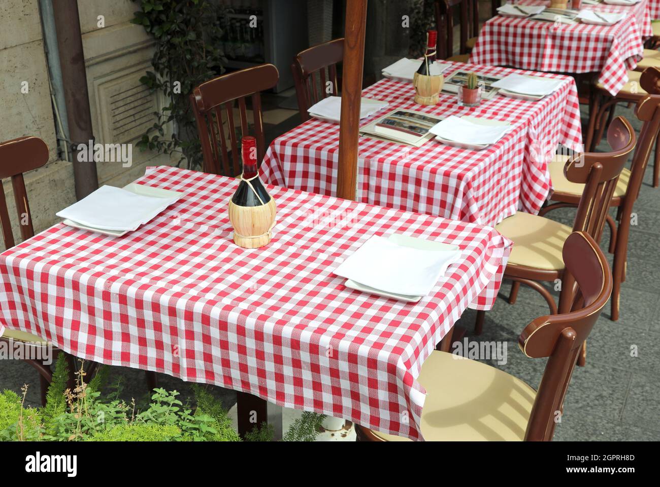 Tovaglia a scacchi rossa e bianca di un ristorante con tavoli all'aperto in  Europa Foto stock - Alamy