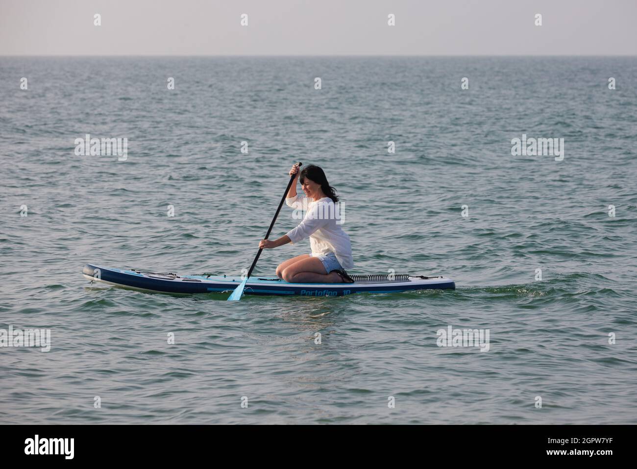 Donna ha visto paddle boarding al mare Regno Unito. Foto Stock