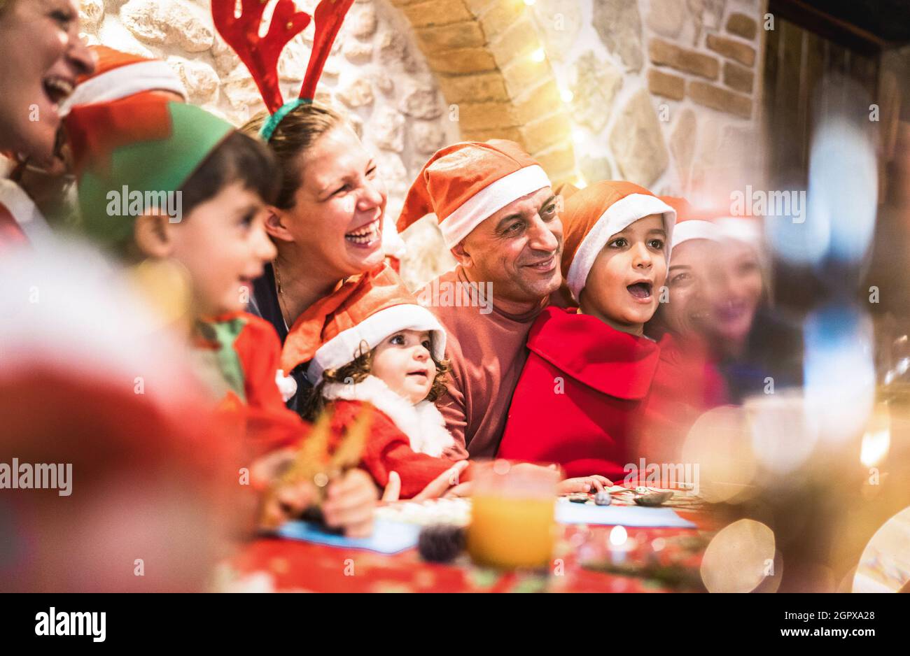 Famiglia multi generazione su abiti santa Hat divertirsi a natale fest casa festa in posa per foto di gruppo - Vacanza invernale x mas concetto Foto Stock