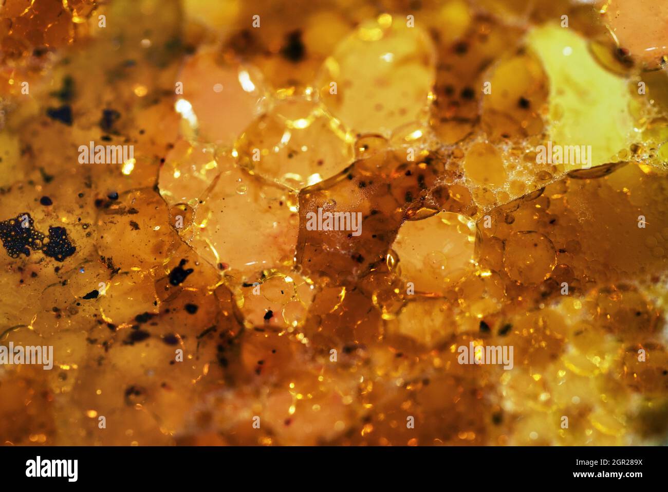 Sfondo astratto giallo ambra con struttura a nido d'ape Foto Stock