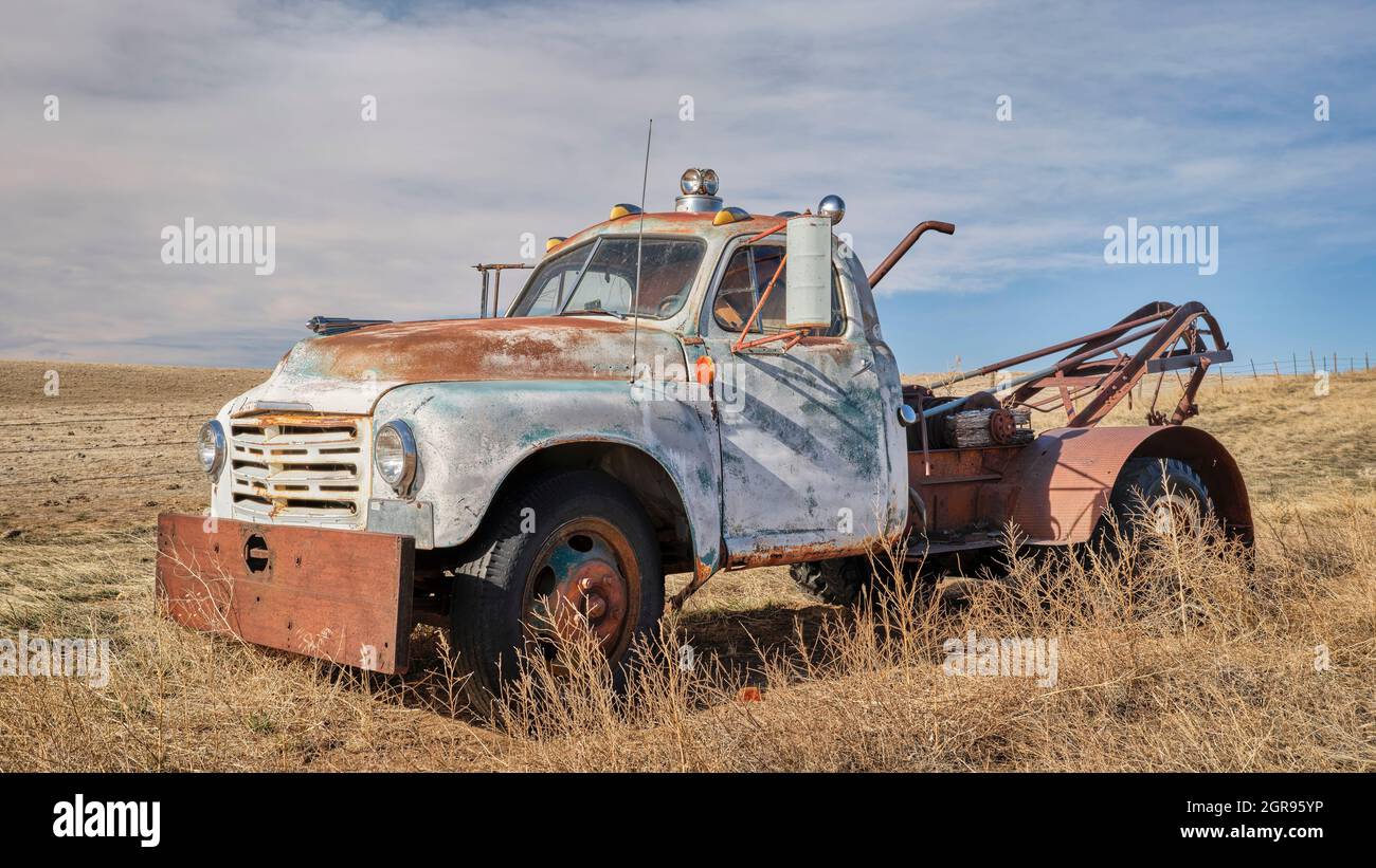 Vecchio camion di traino arrugginito su una prateria, scenario primaverile in Colorado Foto Stock