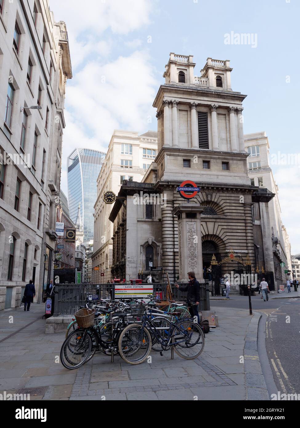 Biciclette parcheggiate fuori dalla stazione della metropolitana di Bank come un artista dipinge. Grattacielo Walkie Talkie dietro. Foto Stock