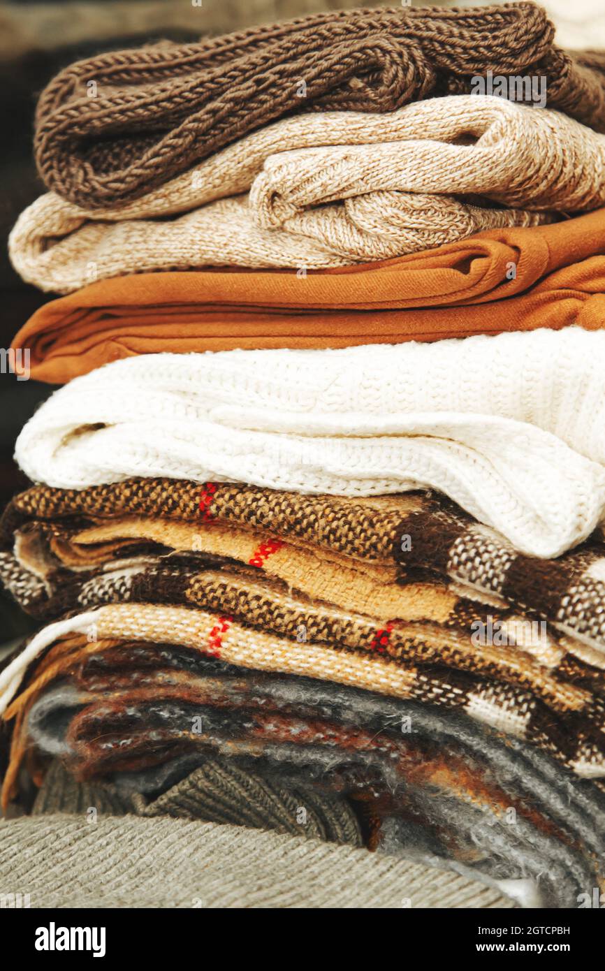 Pila di maglioni caldi e coperte. Tessili di fabbrica. Composizione  autunnale Foto stock - Alamy