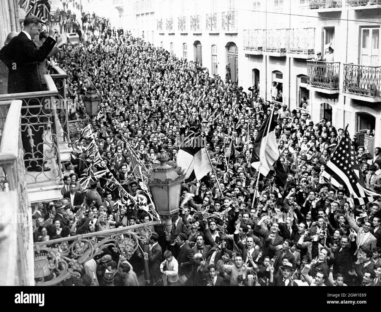 La gente si affollò in strada fuori dagli Stati Uniti e dalle ambasciate britanniche, Lisbona, Portogallo, il giorno di VE, 8 maggio, 1945. Foto Stock