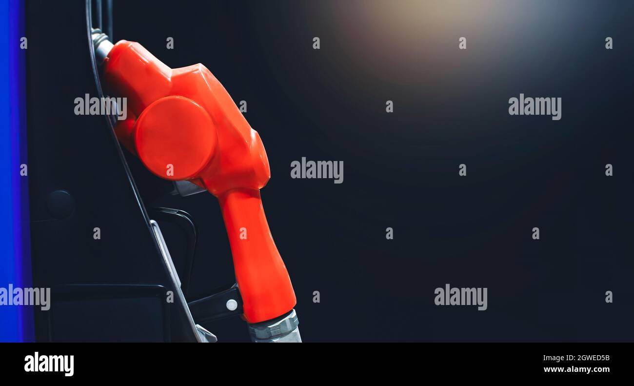 Pompa dell'ugello dell'olio isolata di notte nella stazione di servizio della benzina con sfondo nero e spazio copia, concetto di servizio benzina. Foto Stock