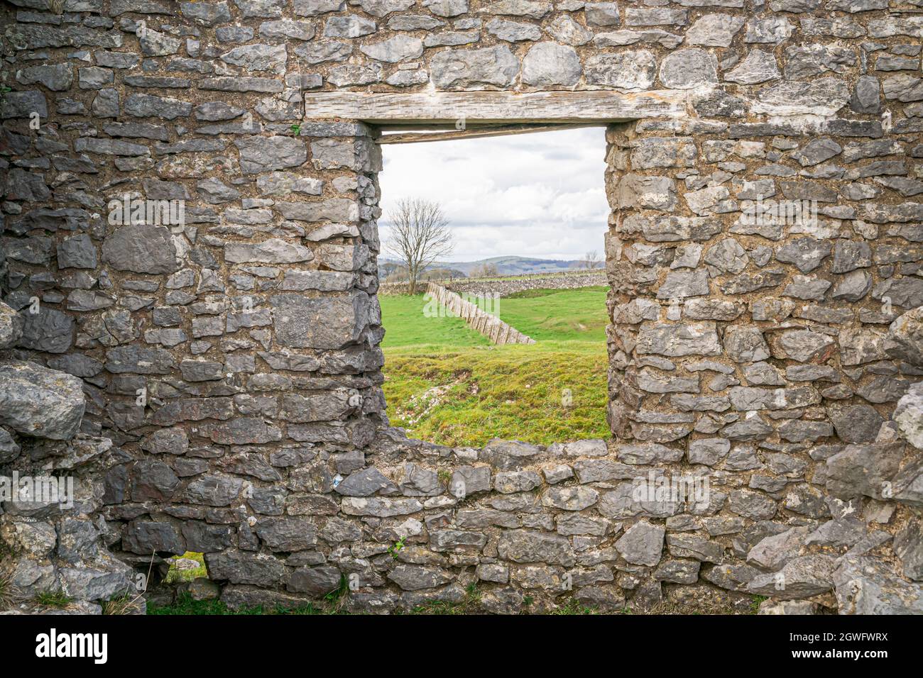 Finestra in rovina di pietra calcarea del 19 ° secolo che mostra il paesaggio e la campagna del Peak District Foto Stock