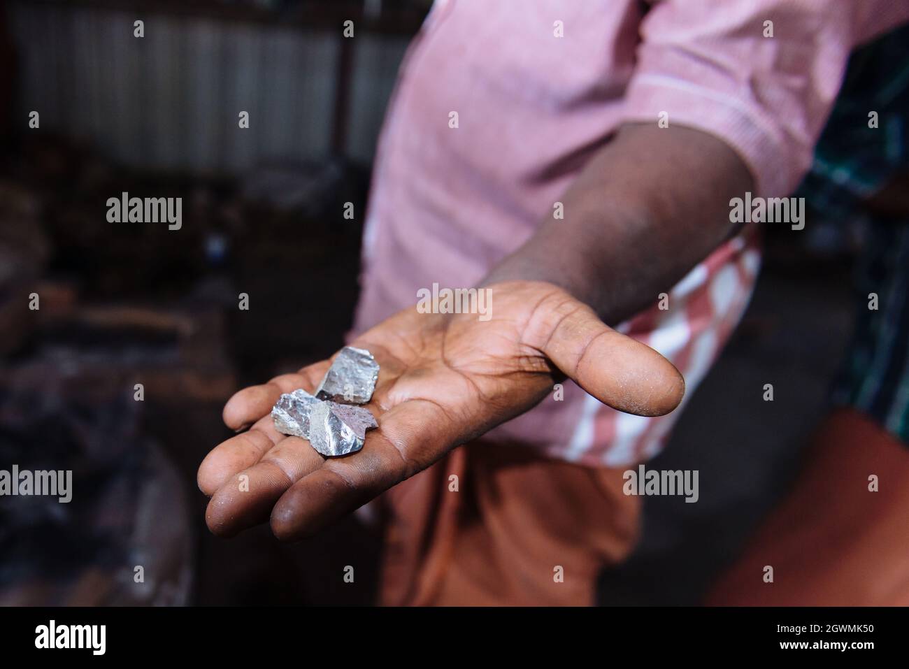 Aranmula, India - 5 dicembre 2015: Kerala. Specchi d'argento produzione fatta a mano in zona rurale, l'uomo fa artigianato unico lavoro d'arte. Piccolo autobus per famiglie Foto Stock