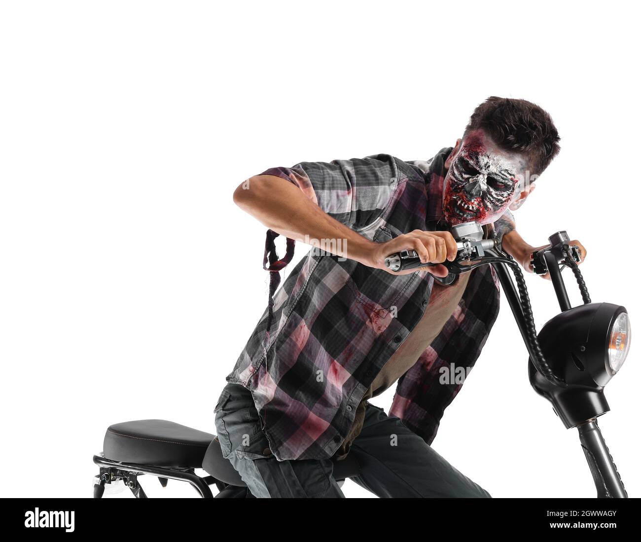 Uomo vestito per Halloween come zombie con moto su sfondo bianco