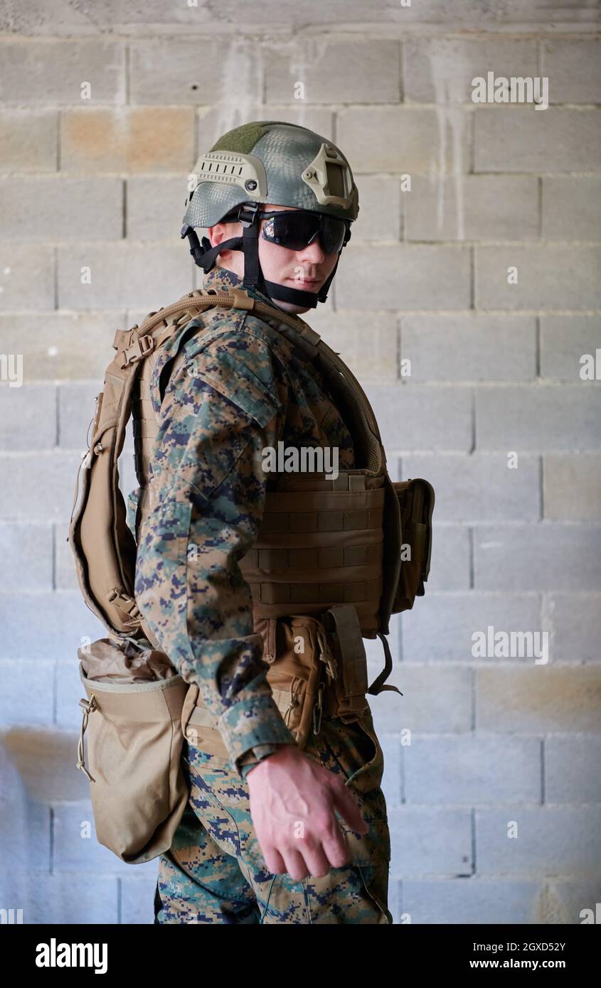 ritratto soldato con equipaggiamento tattico militare protettivo contro  vecchio muro di mattoni Foto stock - Alamy