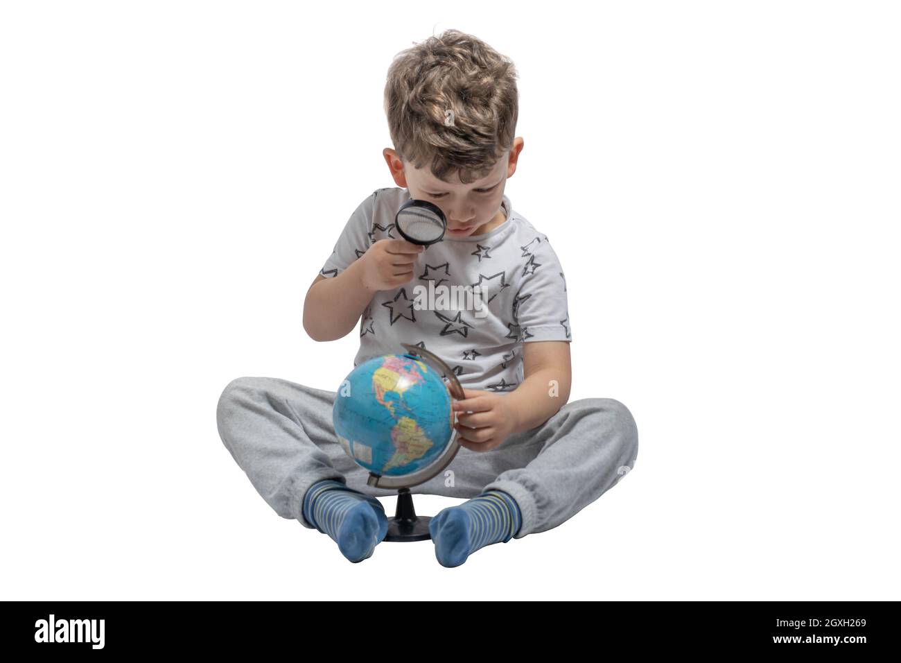 Ragazzo guardando attraverso la lente d'ingrandimento a globo, isolato su sfondo bianco. Scuola, concetto di istruzione. Foto Stock