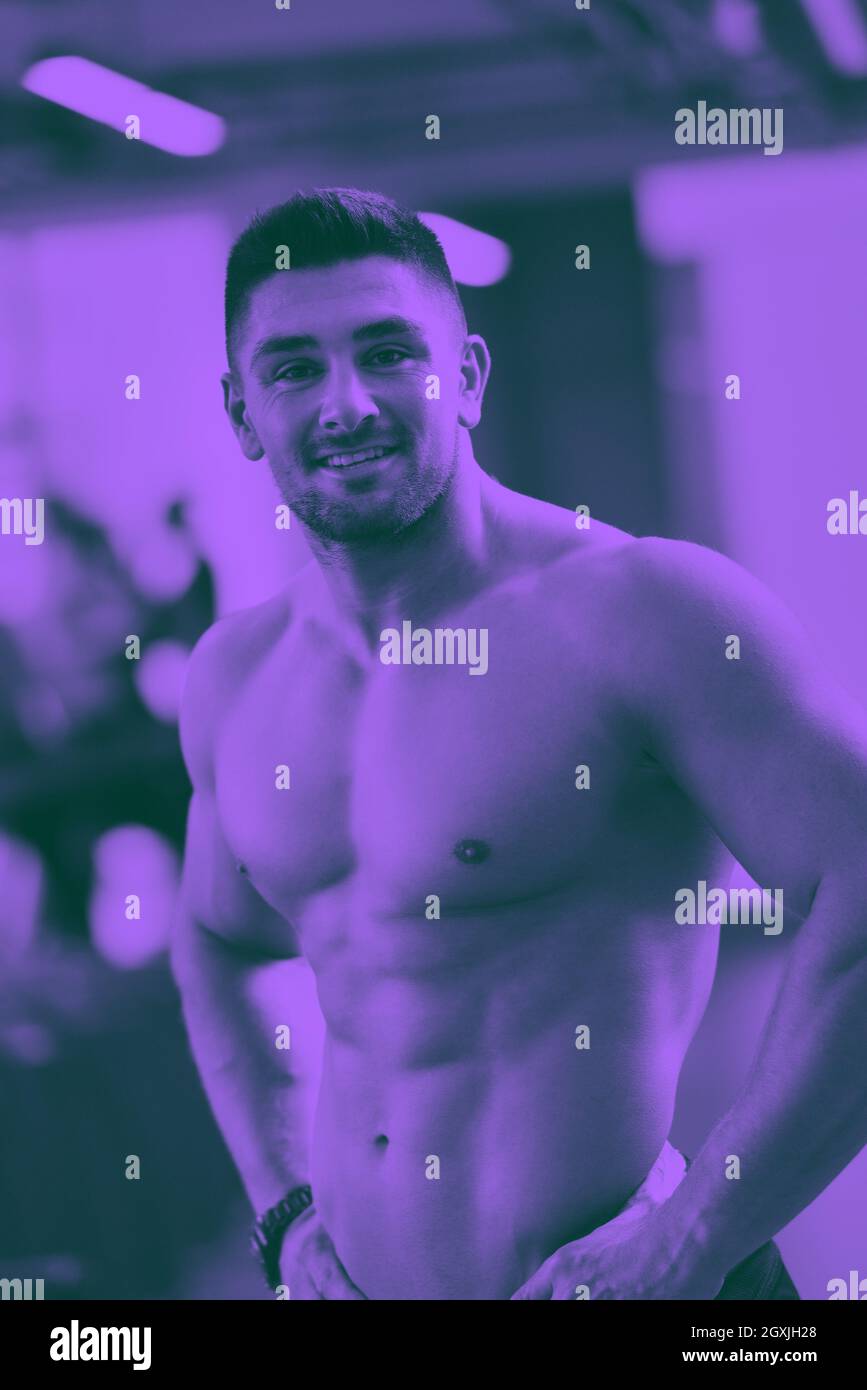 Forte bell'uomo che si esercita in palestra tono duo Foto Stock