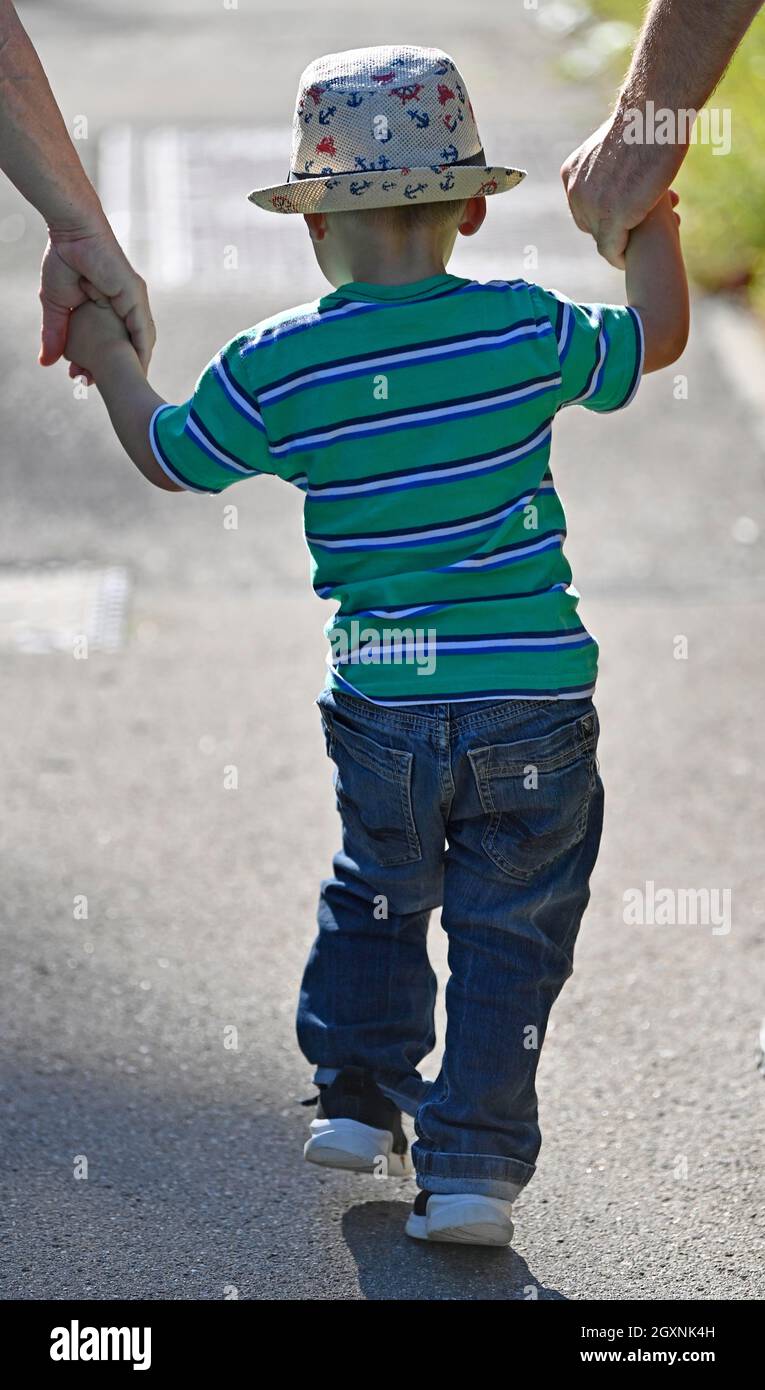 Toddler, 2 anni, multietnico, eurasiatico, è guidato dalle mani, Baden-Wuerttemberg, Germania Foto Stock