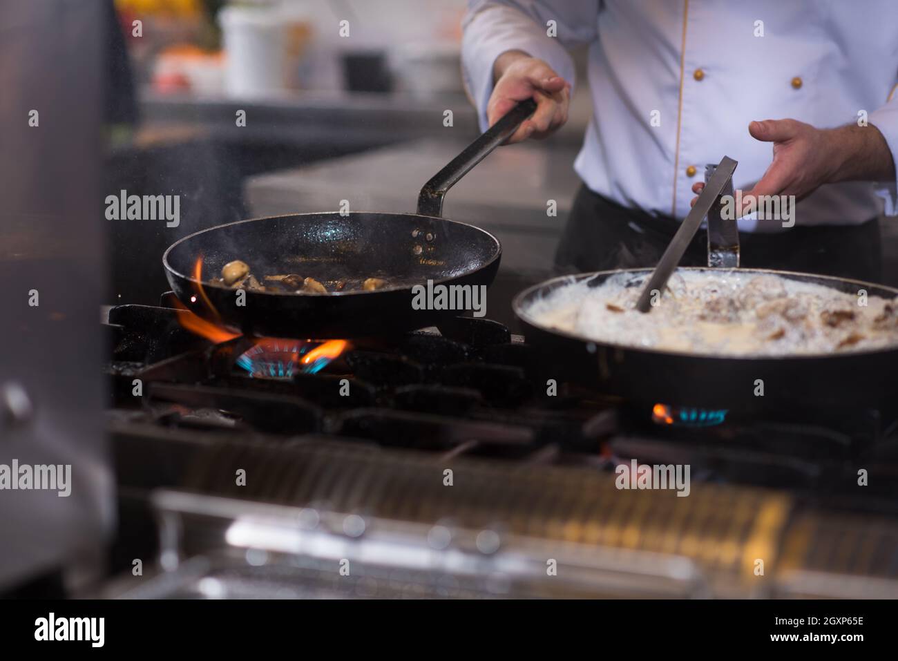 Lo chef prepara cibi, frittura in padella wok. La vendita e il concetto di cibo Foto Stock