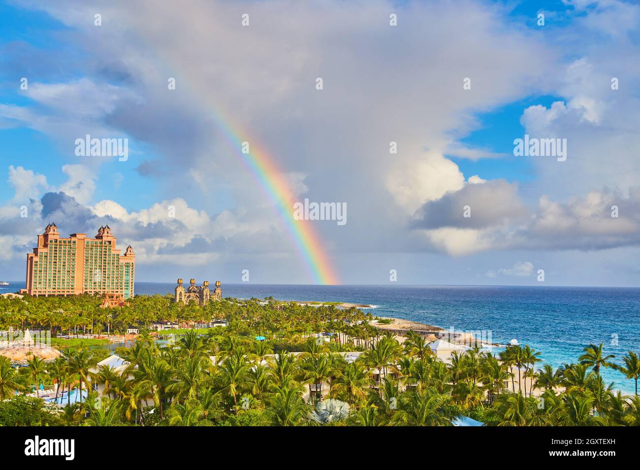 Rainbow sopra l'oceano caraibico sopra l'isola resort coperto da palme Foto Stock