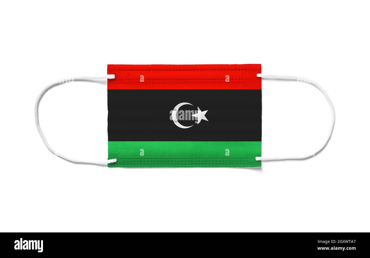 Bandiera della Libia su una maschera chirurgica monouso. Sfondo bianco isolato Foto Stock