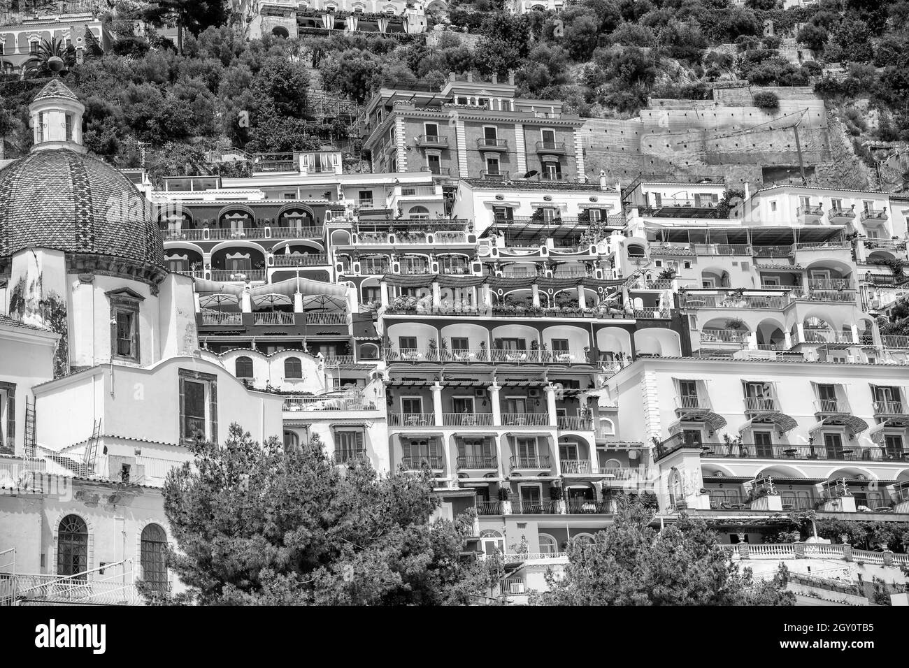 Foto in scala di grigi degli edifici del villaggio di Positano in montagna nella famosa Costiera Amalfitana in Italia Foto Stock
