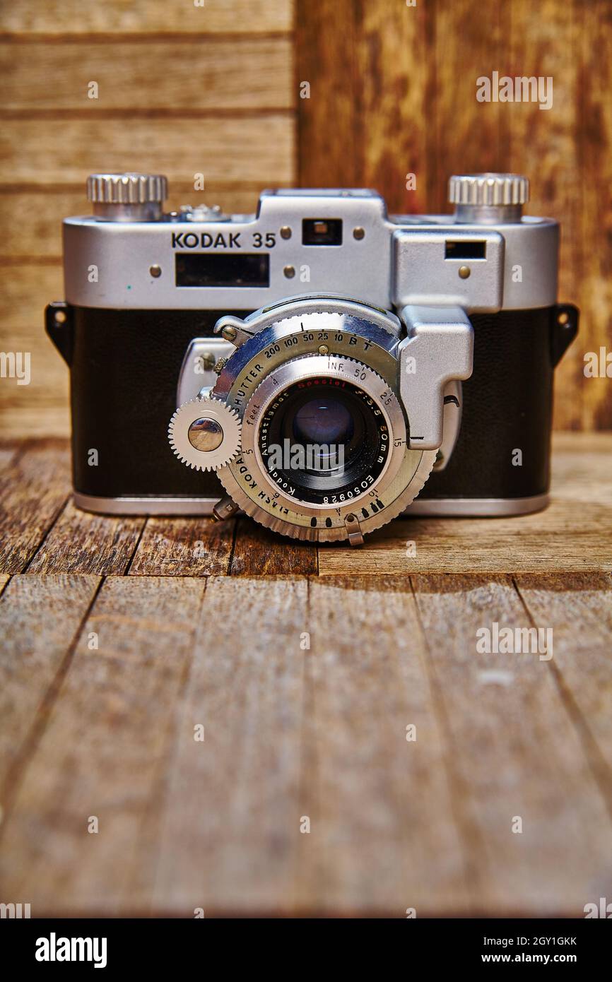 Macchina fotografica antica puntata verso lo spettatore su vari campioni di legno Foto Stock