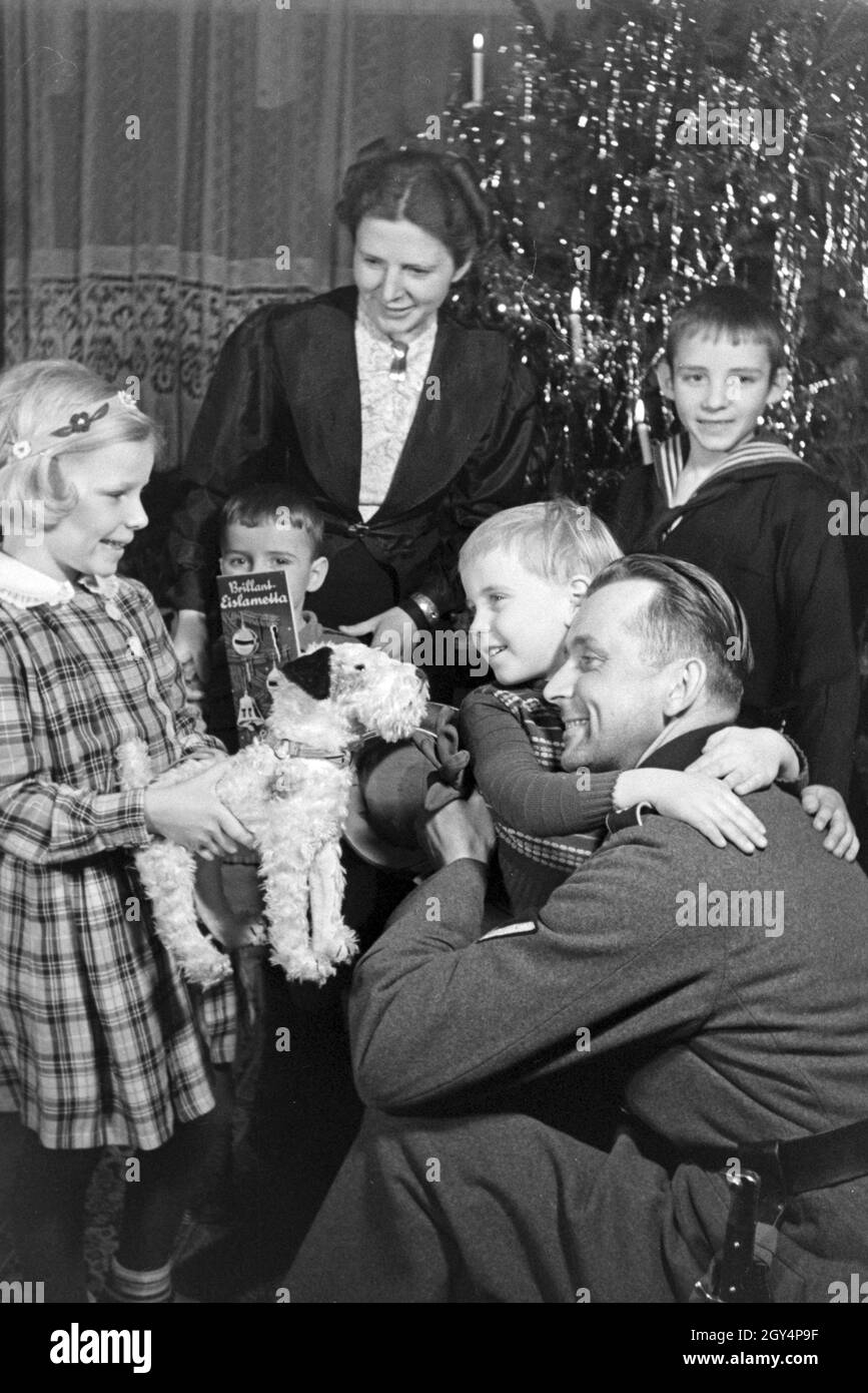 Ein Soldat ist in seinem Weihnachtsurlaub zuhause bei der Familie, Deutschland 1930er Jahre. Un soldato con la sua famiglia nella sua vacanze di natale, Germania 1930s. Foto Stock