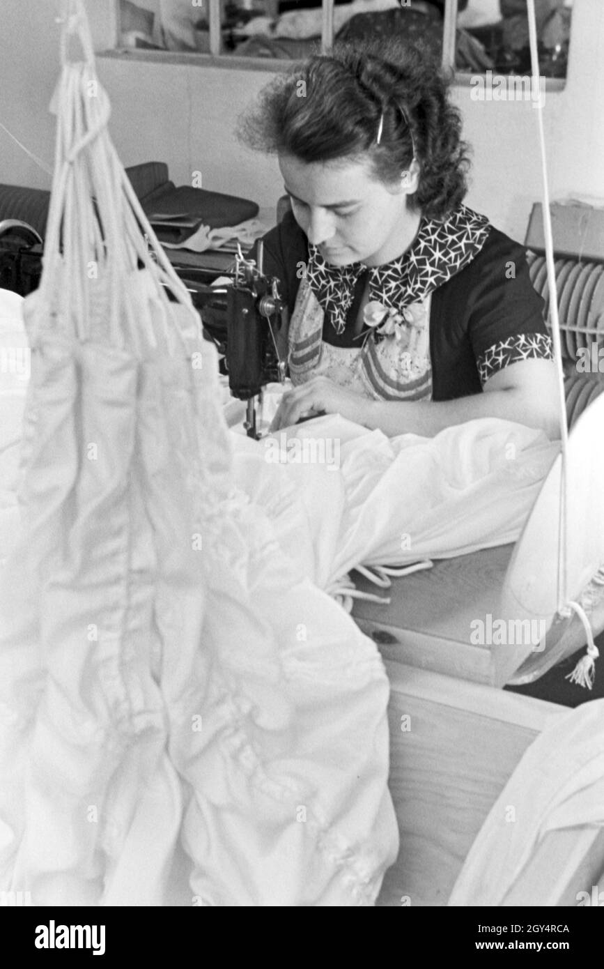 Eine Arbeiterin in einer Fallschirm Näherei; Deutschland 1940er Jahre. Un lavoratore di sesso femminile che a un paracadute stanza del cucito, Germania 1940s. Foto Stock