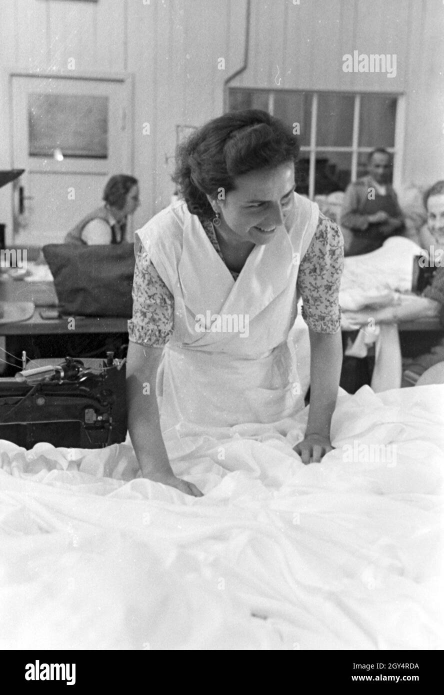 Eine Arbeiterin in einer Fallschirm Näherei; Deutschland 1940er Jahre. Un lavoratore di sesso femminile che a un paracadute stanza del cucito, Germania 1940s. Foto Stock