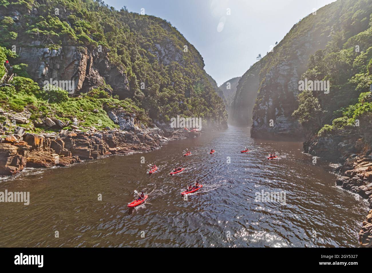 Una vista delle tempeste Gorge del Fiume con un gruppo di kayakers nel fiume alla sezione del Parco Nazionale di Tsitsikamma della Garden Route in Sud Africa. Foto Stock