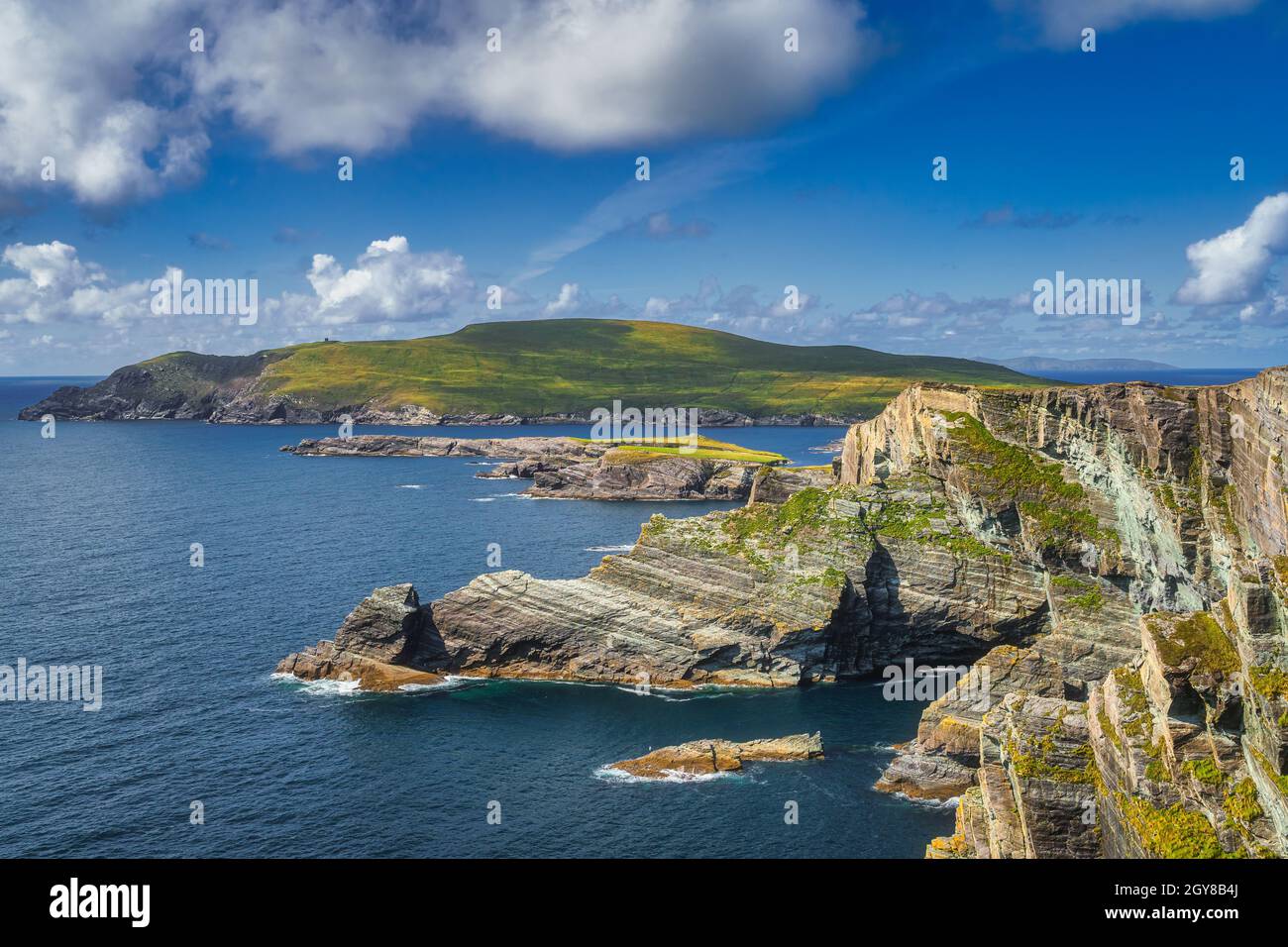 Belle scogliere di Kerry illuminate dalla luce del sole e una vista su Bray Head, Portmagee, penisola di Iveragh, Ring of Kerry, Irlanda Foto Stock