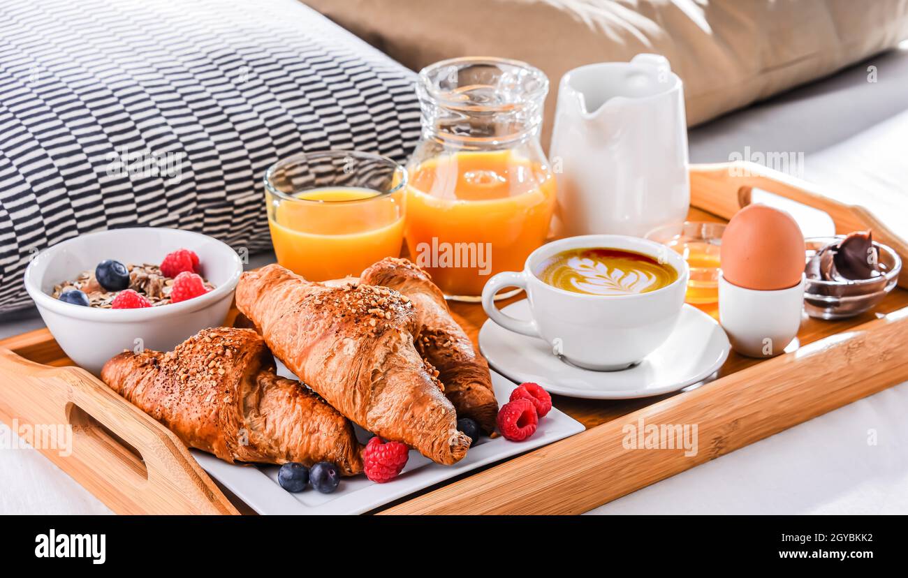 Un vassoio con la prima colazione su un letto in una camera d'albergo Foto  stock - Alamy