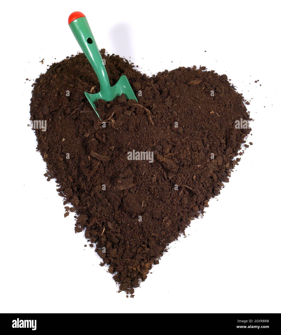 Terreno cuore con pala da giardino isolato su sfondo bianco, Giardinaggio d'amore. Foto Stock