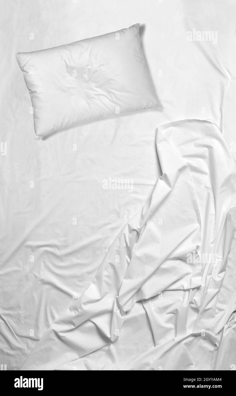 White cuscini e copriletto e cuscino di pelle di pecora su letto di fronte  al vetro con tende bianche in camera con schermo di legno Foto stock - Alamy
