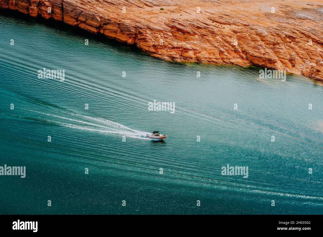 Motoscafo sul lago Powell. Bella acqua color turchese, e rocce rosse sullo sfondo Foto Stock