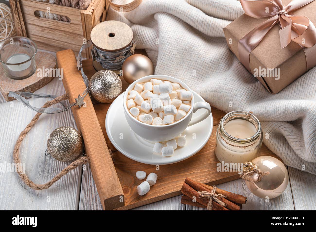 Una tazza di caffè con marshmallows su uno sfondo luminoso festivo. Il concetto di Natale e Capodanno. Vista laterale, primo piano. Foto Stock
