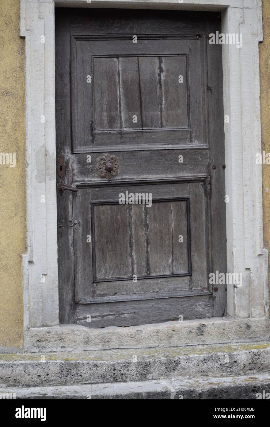 Vecchia porta in legno storto con raccordi arrugginiti Foto Stock